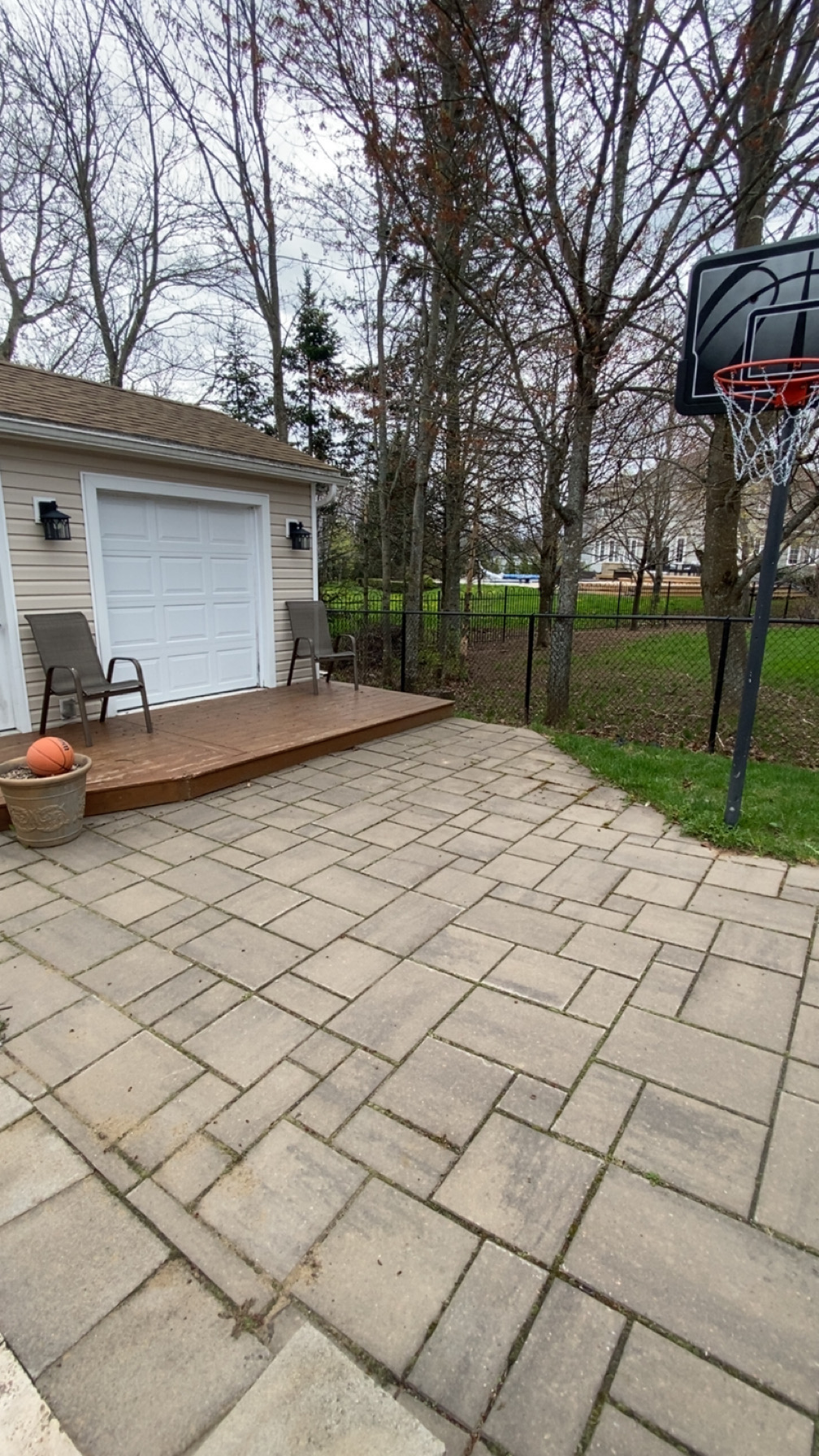 Paver patio with dirt and moss buildup before pressure washing